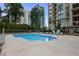 Community swimming pool featuring lounge chairs, landscaping, and city views and no lifeguard on duty at 3445 Stratford Ne Rd # 1605, Atlanta, GA 30326