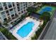 Aerial view of a luxurious pool and sundeck with plenty of lounge chairs and manicured landscaping at 3445 Stratford Ne Rd # 1605, Atlanta, GA 30326