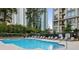 Sparkling community pool with lounge chairs, landscaping, and city views and no lifeguard on duty at 3445 Stratford Ne Rd # 1605, Atlanta, GA 30326