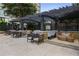 Relaxing poolside lounge area with modern seating, pergola, privacy landscaping and shade at 3445 Stratford Ne Rd # 1605, Atlanta, GA 30326