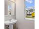 Bathroom with pedestal sink and a window with a view of the neighborhood at 5615 Hislop Lane # 82, Mableton, GA 30126