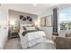 Comfortable bedroom featuring grey walls, a tufted headboard, and natural light at 8518 Polston Place Lot 131, Douglasville, GA 30134