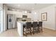 Bright kitchen with stainless steel appliances, a center island with seating, and white cabinetry at 8518 Polston Place Lot 131, Douglasville, GA 30134