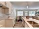 Bright kitchen island with stainless steel sinks, pendant lights, and views into the living room and dining area at 2702 Ne Almand Lane, Conyers, GA 30013