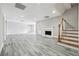 Basement with wood-look flooring, fireplace, staircase, and ample space for customization at 2984 Berry Rd, Loganville, GA 30052