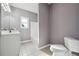A clean bathroom has a single vanity, toilet, and a shower-tub combo, finished with tile flooring at 2984 Berry Rd, Loganville, GA 30052