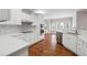 Modern kitchen with white cabinets, stainless steel appliances, and hardwood floors at 2984 Berry Rd, Loganville, GA 30052