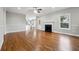 Open-concept living room with hardwood floors, a fireplace, and backyard access at 2984 Berry Rd, Loganville, GA 30052
