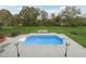 Inviting pool with a serene green backdrop for relaxing and unwinding in your backyard oasis at 2984 Berry Rd, Loganville, GA 30052
