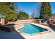 Sparkling in-ground pool with hot tub, outdoor fireplace, and a spacious yard at 330 Todwick Dr, Roswell, GA 30075