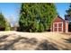 Large backyard featuring a storage shed, spacious lawn, and mature trees at 330 Todwick Dr, Roswell, GA 30075