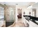 Spacious bathroom featuring a walk-in shower, double sink vanity, and access to the main bedroom at 330 Todwick Dr, Roswell, GA 30075