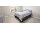 A cozy bedroom with a metal frame bed, soft carpet, and natural light from the window at 330 Todwick Dr, Roswell, GA 30075