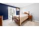 Cozy bedroom featuring a wooden bed frame, bedside table with a lamp, and a window with natural light at 330 Todwick Dr, Roswell, GA 30075