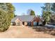 Charming single-story brick home with a well-manicured lawn and beautiful landscaping at 330 Todwick Dr, Roswell, GA 30075