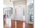 Bright foyer with hardwood flooring, white trim, and view into adjoining rooms at 330 Todwick Dr, Roswell, GA 30075