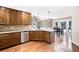 Kitchen featuring granite countertops, wood cabinets, hardwood floors and stainless steel dishwasher at 330 Todwick Dr, Roswell, GA 30075