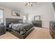 Spacious bedroom with a black platform bed, ample natural light, and dark wood furniture at 9225 Wilshire Pl, Cumming, GA 30028