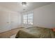 Bright bedroom featuring neutral decor, complemented by an ensuite and side chair, creating a calming atmosphere at 9225 Wilshire Pl, Cumming, GA 30028