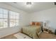 Bright bedroom featuring neutral decor, complemented by an ensuite and side chair, creating a calming atmosphere at 9225 Wilshire Pl, Cumming, GA 30028