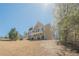 Beautiful two-story home with stone accents, red shutters, attached garage, and well-maintained lawn at 9225 Wilshire Pl, Cumming, GA 30028