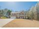Charming two-story home with stone accents, red shutters, attached garage, and well-maintained lawn at 9225 Wilshire Pl, Cumming, GA 30028