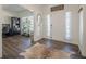 Inviting foyer with hardwood floors, a stylish rug, natural light, and a view to the front door at 9225 Wilshire Pl, Cumming, GA 30028