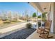 Inviting covered front porch with hanging plants, rocking chairs, and a view of the neighborhood at 9225 Wilshire Pl, Cumming, GA 30028