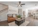 Inviting living room with a plush leather sofa, ceiling fan, and modern decor at 9225 Wilshire Pl, Cumming, GA 30028