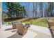 Inviting patio with comfortable wicker seating and a fire pit, perfect for outdoor relaxation at 9225 Wilshire Pl, Cumming, GA 30028