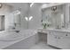 Spacious white bathroom featuring a soaking tub, vanity area, and large mirror at 3995 Vista Point Ln, Suwanee, GA 30024