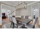 Bright dining room features modern chandelier, hardwood floors, and space for entertaining at 3995 Vista Point Ln, Suwanee, GA 30024