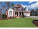 A red brick two-story home with large front yard at 3995 Vista Point Ln, Suwanee, GA 30024