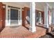 Inviting front porch with brick flooring, white columns, and a stylish front door at 3995 Vista Point Ln, Suwanee, GA 30024