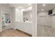 Spacious bathroom with double sinks, wood flooring, and a walk-in closet view at 8523 Poston Place Lot 132, Douglasville, GA 30134