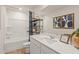 Well-lit bathroom featuring a shower-tub combo, white vanity, and modern decor at 8523 Poston Place Lot 132, Douglasville, GA 30134