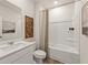 Clean bathroom with a white vanity, toilet, and shower-tub combination at 8523 Poston Place Lot 132, Douglasville, GA 30134
