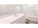 Well-lit bathroom with white cabinets, tub, and a large mirror at 8523 Poston Place Lot 132, Douglasville, GA 30134