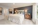 Well-decorated bedroom featuring neutral tones, a blue accent wall, and elegant furniture at 8523 Poston Place Lot 132, Douglasville, GA 30134