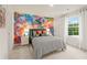 Bright bedroom with a colorful mural wall and a large window overlooking green trees at 8523 Poston Place Lot 132, Douglasville, GA 30134