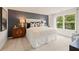 Bright bedroom featuring a large window, blue accent wall, and stylish furniture at 8523 Poston Place Lot 132, Douglasville, GA 30134