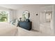 Cozy bedroom with a round mirror, comfortable chair, and a view of the laundry room at 8523 Poston Place Lot 132, Douglasville, GA 30134