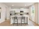 Modern kitchen with stainless steel appliances, island seating, and bright natural light at 8523 Poston Place Lot 132, Douglasville, GA 30134