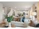 Bright living room featuring an open floor plan with a modern kitchen and staircase at 8523 Poston Place Lot 132, Douglasville, GA 30134
