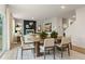 Open-concept living and dining area with modern decor and a cozy fireplace feature wall at 8523 Poston Place Lot 132, Douglasville, GA 30134