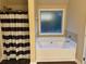 Bright bathroom featuring a soaking tub with a window view and a shower with a stylish striped curtain at 3624 Peeksville Rd, Locust Grove, GA 30248