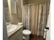 Bathroom with a vanity and a toilet covered by a curtain with a nature theme at 3624 Peeksville Rd, Locust Grove, GA 30248