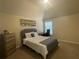 Cozy bedroom with neutral colors, a comfortable bed, and a dedicated workspace near the window at 3624 Peeksville Rd, Locust Grove, GA 30248