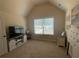 Bright bedroom featuring carpeted floor, neutral colors, TV, and a window at 3624 Peeksville Rd, Locust Grove, GA 30248