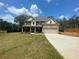 Inviting two-story home featuring a brick facade, covered porch, and well-manicured lawn at 3624 Peeksville Rd, Locust Grove, GA 30248